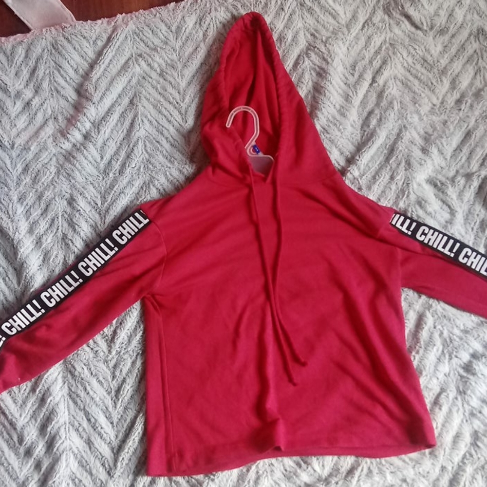 A red crop top with hood